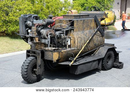 Slurry Machine lays down hot slurry to reseal a blacktop driveway, street rehabilitation and slurry seal project finished with crews expertly applying the slurry seal. 
