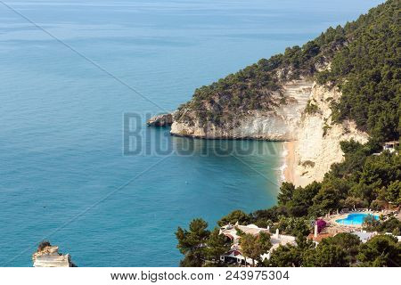 Mattinata, Italy - June 06, 2017: Picturesque Islets Faraglioni Di Puglia In Summer Adriatic Sea Bay