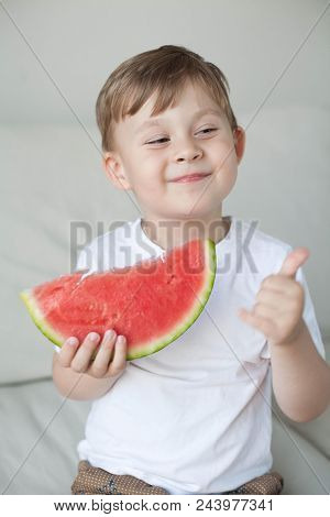 A Small Cute Boy 4 Years Old Is Eating A Watermelon. Summer. Heat. Watermelon. Portrait Of A Happy B