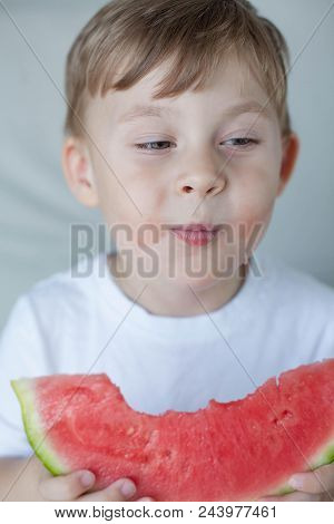 A Small Cute Boy 4 Years Old Is Eating A Watermelon. Summer. Heat. Watermelon. Portrait Of A Happy B