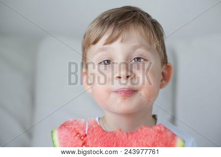 A Small Cute Boy 4 Years Old Is Eating A Watermelon. Summer. Heat. Watermelon. Portrait Of A Happy B