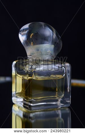 Bottle Of Perfume Spraying, Isolated On Black Background