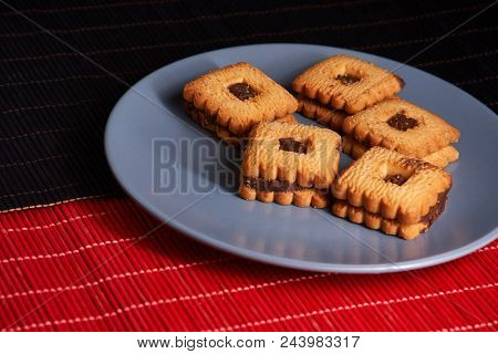 Stacked Chocolate Chip Cookies On Gray Style Plate
