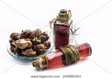 Sweet And Floral Essence Of Date Or Khajoor In Bottles Isolated On White Used In Flavored Chocolate 