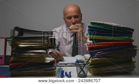 Businessman Eating A Sandwich And Take Breakfast In Office Room