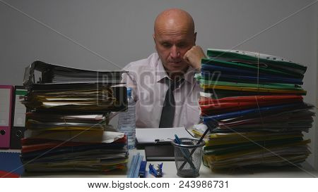Preoccupied Businessman Reading Financial Documents In Accounting Archive Room