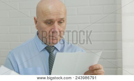 Businessman Image Reading Documents And Contracts In Office Room