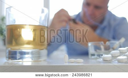Man Reading Pills Prescription Before Drinking Alcohol