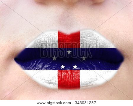 Female Lips Close Up With A Picture Flag Of Netherlands Antilles. Learning Languages.