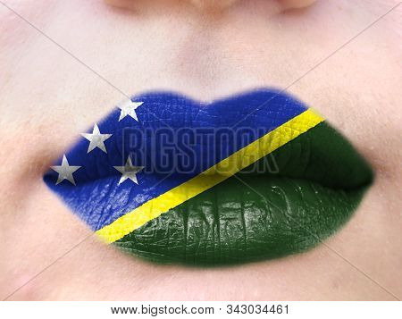 Female Lips Close Up With A Picture Flag Of Solomon Islands. Learning Languages.