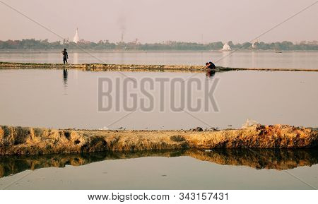 Fisherman Working On The Lake In Early Morning