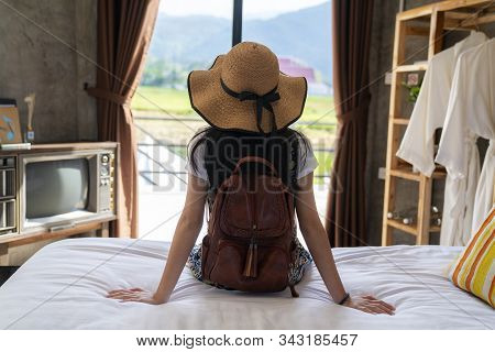 Thai Girl Relax In Bed Room With Country Background  In Her Home Stay, Pua, Nan, Thailand.