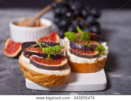Sandwich With Cream Cheese, Figs, Honey Served On The White Cutboard On The Concrete Background. Hea