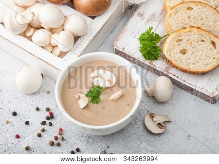 White Bowl Plate Of Creamy Chestnut Champignon Mushroom Soup On Light Kitchen Background And Box Of 