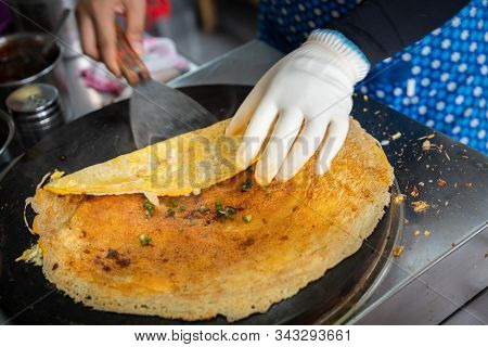 Woman Folding And Making Savoury Egg Pancake In A Small Local Street Outlet Bakery In Yichang Town, 