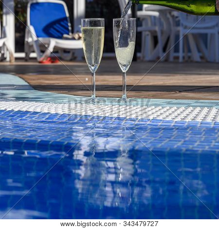 Pool Party With Two Glasses With  Bubbles White Champagne Or Cava Wine, Romantic Event Or All Inclus