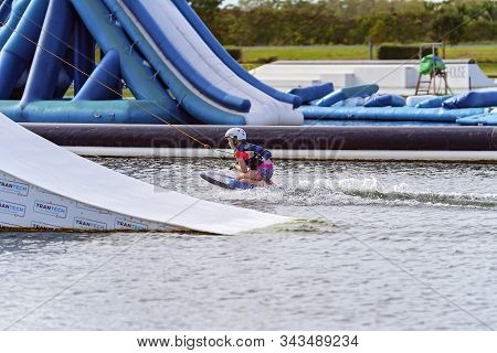 Mackay, Queensland, Australia - January 2020: A Child Wearing A Safety Helmet And Life Jacket Enjoyi
