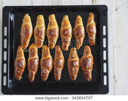 Ready-made Toasted Homemade Bagels On A Black Baking Sheet From The Oven. Ready To Eat. Sprinkled Wi