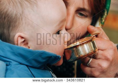 Voyutyn, Volyn / Ukraine - October 14 2009: Habd Of Priest Conduct The Communion Rite During The Chu