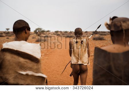 Original Native Bushman From Namibia With Traditional Clothing From Behind