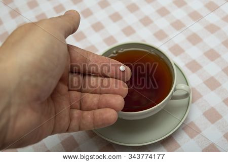 A Small Sweetener Tablet, A Sugar Substitute In Your Hand For Adding To A Cup Of Tea