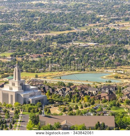 Square Frame Temple And Geart Shaped Lake Amid Buildings And Houses In Salt Lake City Utah