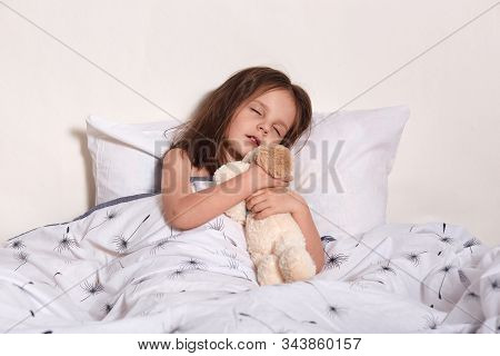 Image Of Charming Magnetic Little Infant Sleeping In Her Light Bedroom Alone, Lying In Soft Cosy Bed