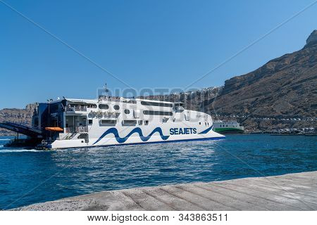 Santorini Greece - August 11 2019;  Seajects Greek Island Ferryboat Arriving In Port Athinos.