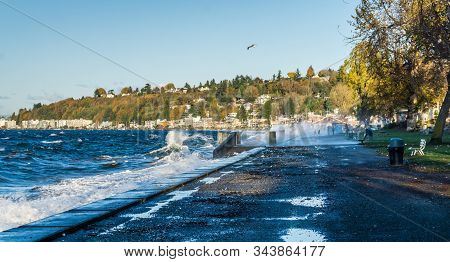 Waves Crash Onto The Shore At Alki Beach In West Seattle, Washington.