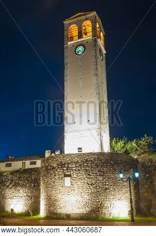 Sahati clock tower and castle walls illuminated after sunset. Elbasan, Albania