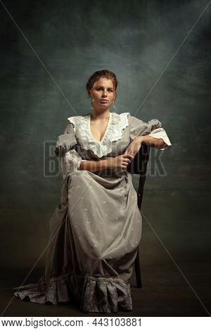 Vintage Portrait Of Young Beautiful Girl In Gray Dress Of Medieval Style Isolated On Dark Background