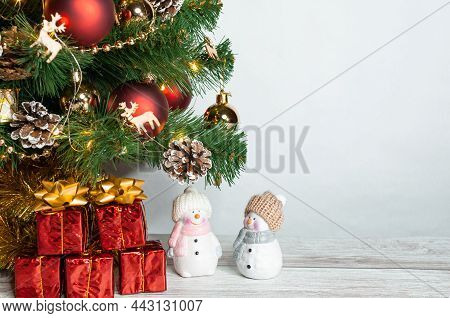 Part Of A Christmas Tree With Bright Toys On A White Background. Red Christmas Toys. Red Little Gift