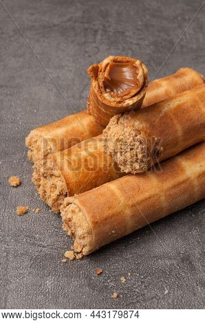 Tatsy Waffle Tubes With Boiled Condensed Milk On A Gray Background