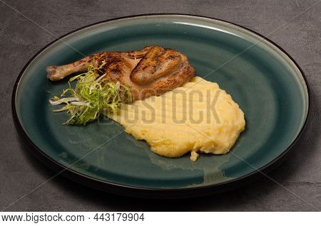 Tatsy Quail With Mashed Potatoes On A Green Plate On A Gray Background