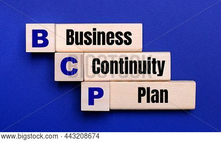 On A Bright Blue Background, Light Wooden Blocks And Cubes With The Text Bcp Business Continuity Pla