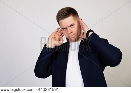 A Young Man Covering His Ears With His Hands, He Does Not Want To Listen To News, Gossip, Informatio