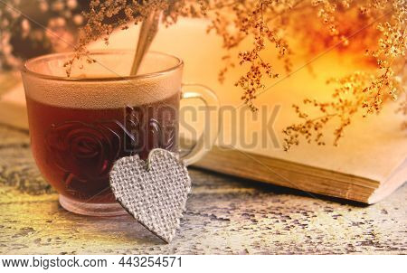 Brurred Dry Flowers On Vintage Notepad, Cup Of Tea  On Wooden Table. Retro Style, Vintage Toned