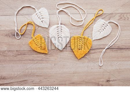 Macrame Leaves In Yellow  And Natural Color On The Wooden Background. Cotton Rope Decor Macrame To M