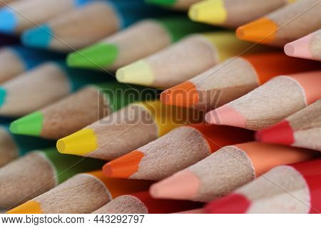 Close-up Of Sharpened Colourful Pencil Set For Painting Forming Stack. Pigmented Crayons For Drawing