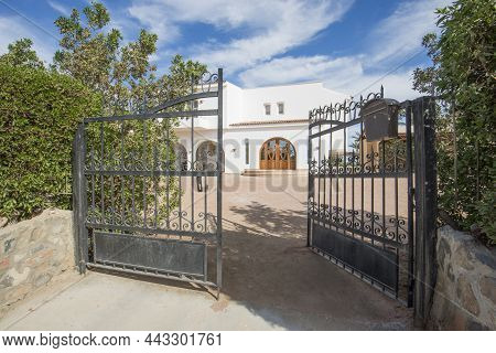Luxury Villa Show Home Exterior View In A Tropical Resort With Private Garden And Metal Gates
