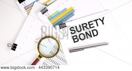 Surety Bond Text On White Paper On Light Background With Charts Paper