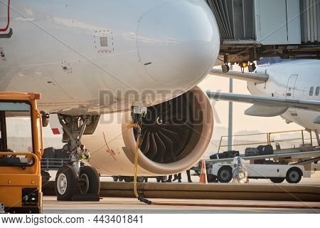 Plane With Jetway In The Evening. Passenger Boarding. Airport Ground Service And Maintenance. Boardi