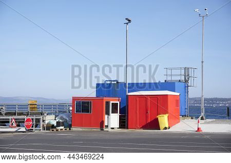 Red And Blue Storage Containers At Ferry Port In Oban Scotland