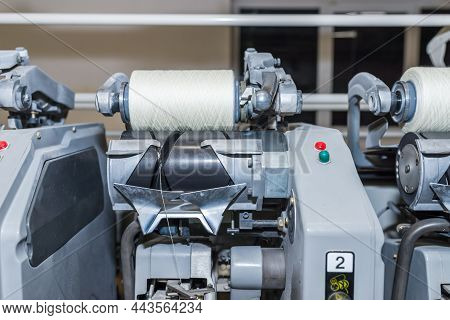 Cotton Yarn Production In A Textile Factory. Textile Fabric Manufacturing Machines In Work. Row Of A