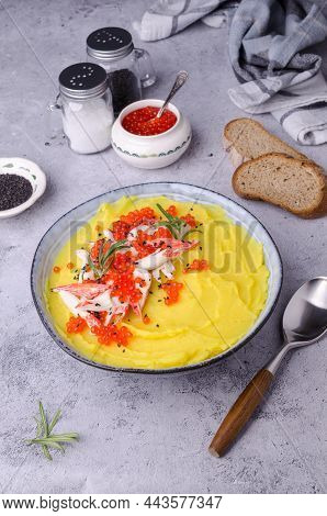 Yellow Puree With Crab Meat And Red Caviar. Stone Background. Selective Focus.