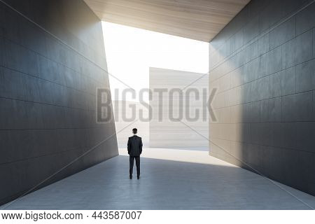 Male Standing In Abstract Concrete Tile Space Interior Background With Sunlght. Design And Abstracti