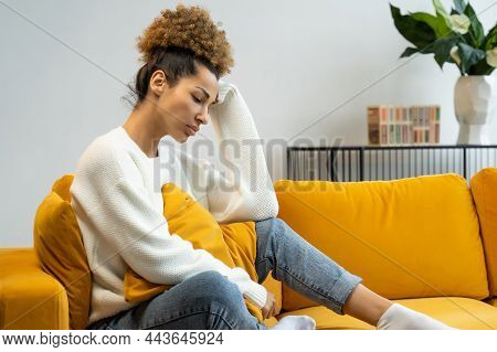 Sad Young Black Woman Is Sitting Alone At Home, Feeling Depressed, Upset, A Woman Suffering From Gri