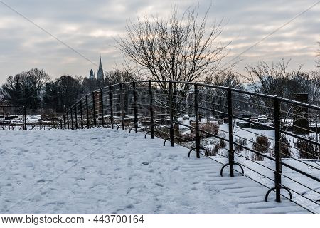 Snow, Bare Trees And A Food Bridge In The Stuyvenberg City Park, Brussels