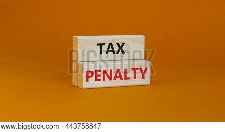 Time To Tax Penalty Symbol. Concept Words Tax Penalty On Wooden Blocks On A Beautiful Orange Backgro