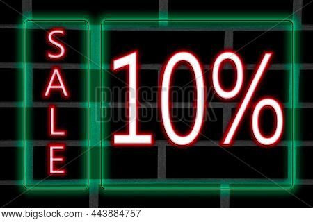 Pink Neon Inscription 10 Percent Discount In Green Neon Frame On Brick Wall Background